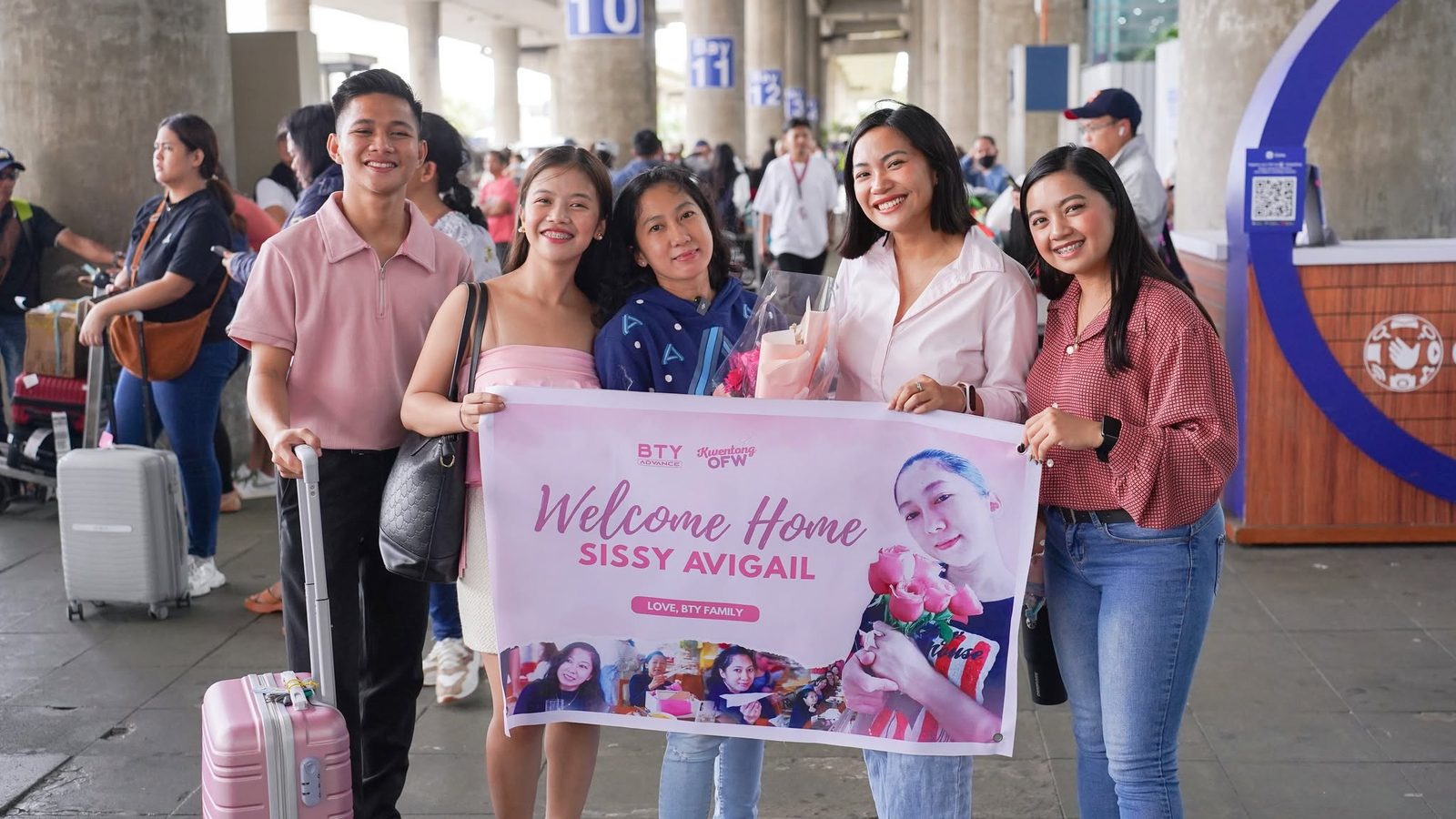 The BTY team welcoming Sissy Avigail home at the airport with a Welcome Home banner
