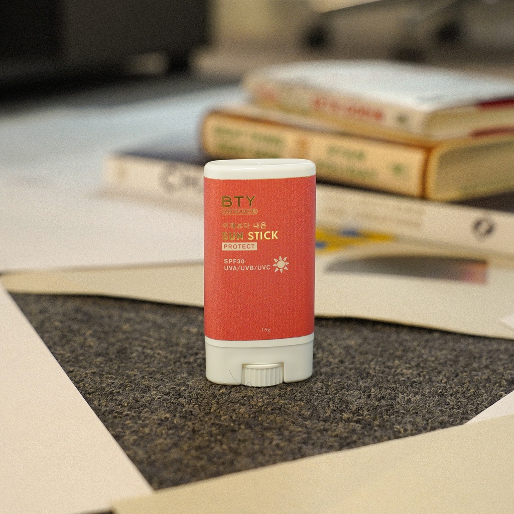 BTY Advance Sun Stick on a stack of books